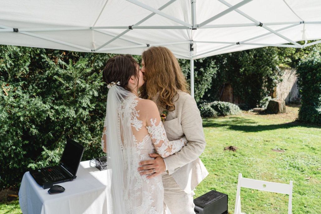 Kuss des Brautpaares bei der freien Trauung im Garten